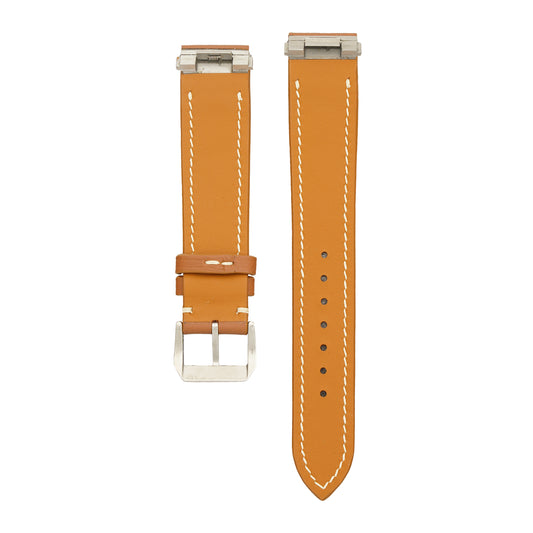 Underside of the brown Swift Cartier Roadster strap, showing the steel clip-in inserts at both case ends and the tan calfskin lining, flat lay.