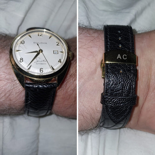 Black ostrich leg leather watch strap fitted to a Bulova watch, showing front wrist fit and buckle side.