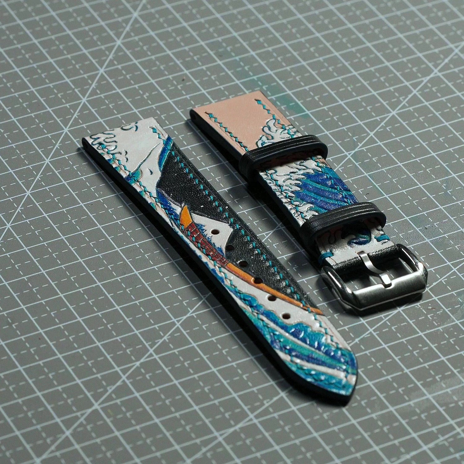 Hand-carved and hand-painted Great Wave leather watch strap showing carved relief and painted details