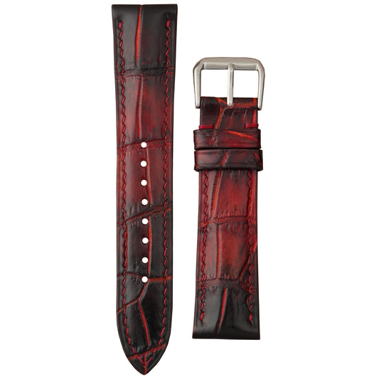 Burnt red Bordeaux crocodile leather watch strap with matching red stitching and a silver buckle, flat lay.