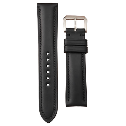 Black Buttero leather watch strap with black stitching and a silver buckle, flat lay.