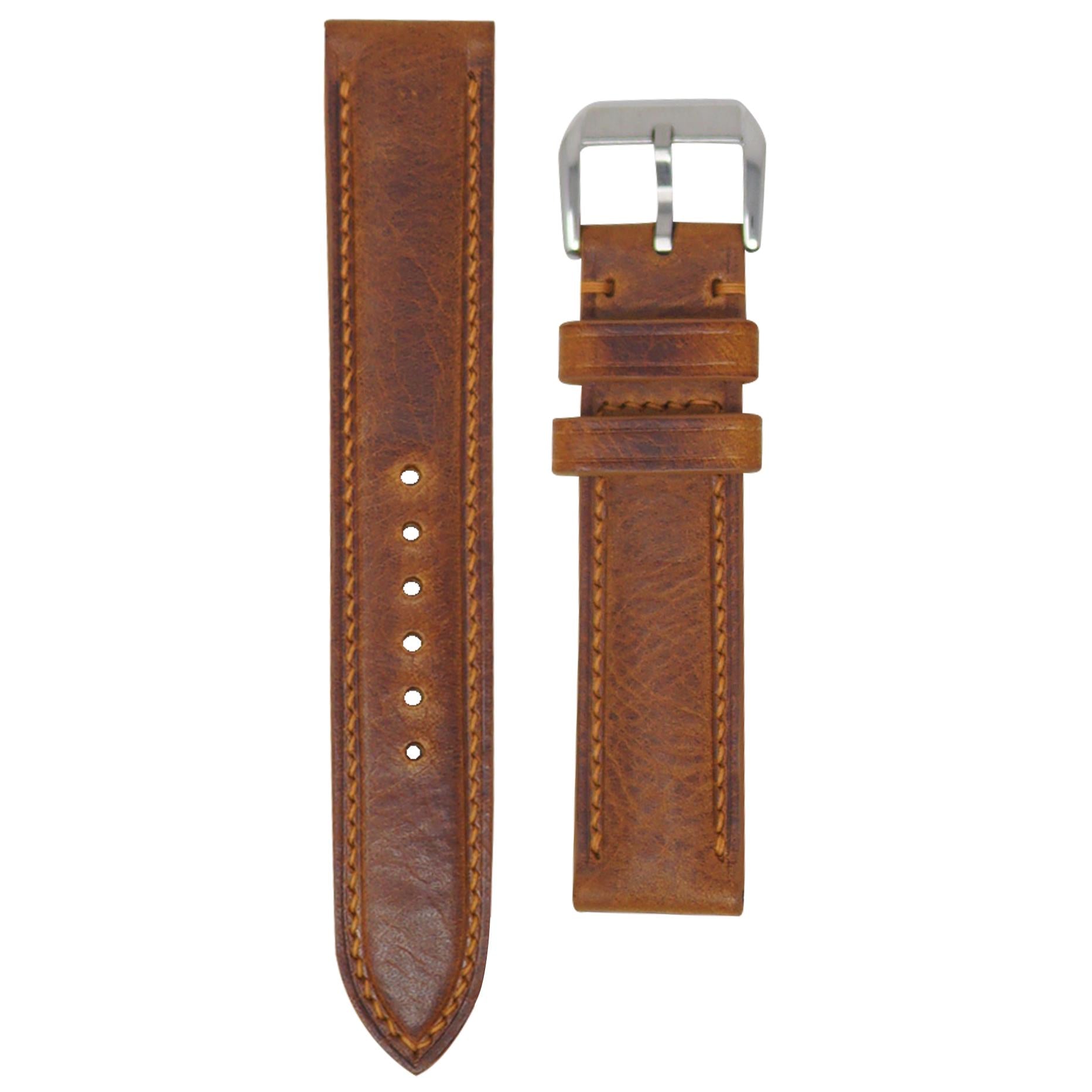 Cognac Badalassi Wax leather watch strap with matching stitching and a silver buckle, flat lay.