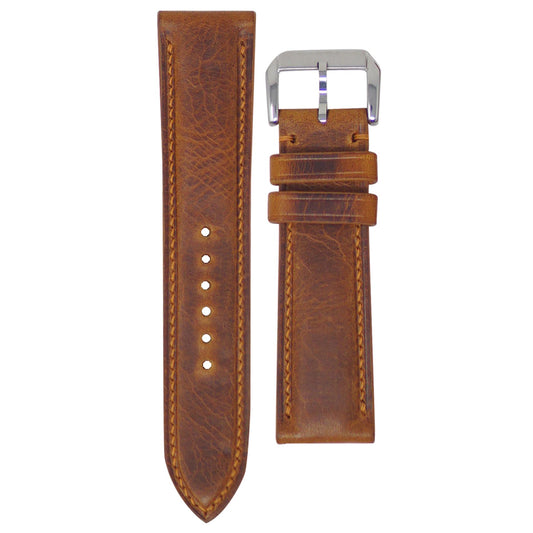 Cognac Badalassi Wax leather watch strap, 22mm, with light brown stitching and a silver buckle, flat lay.