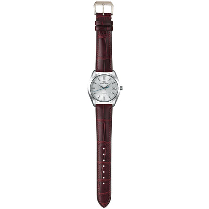 Burgundy crocodile leather watch strap fitted to a white-dial dress watch, shown in a full-length flat lay.