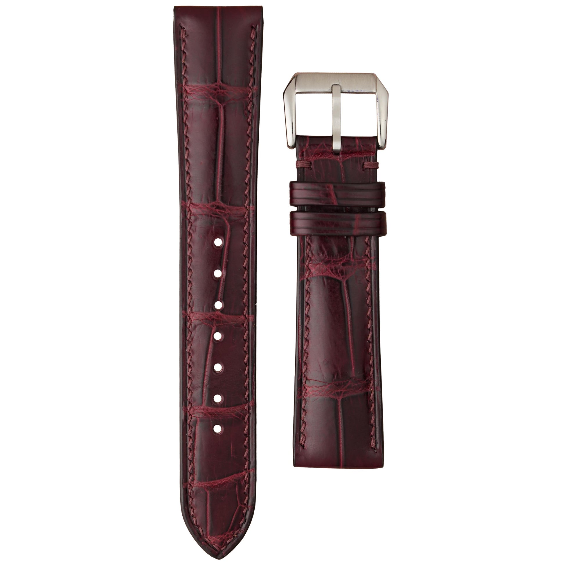 Burgundy crocodile leather watch strap with matching stitching and silver buckle, flat lay.