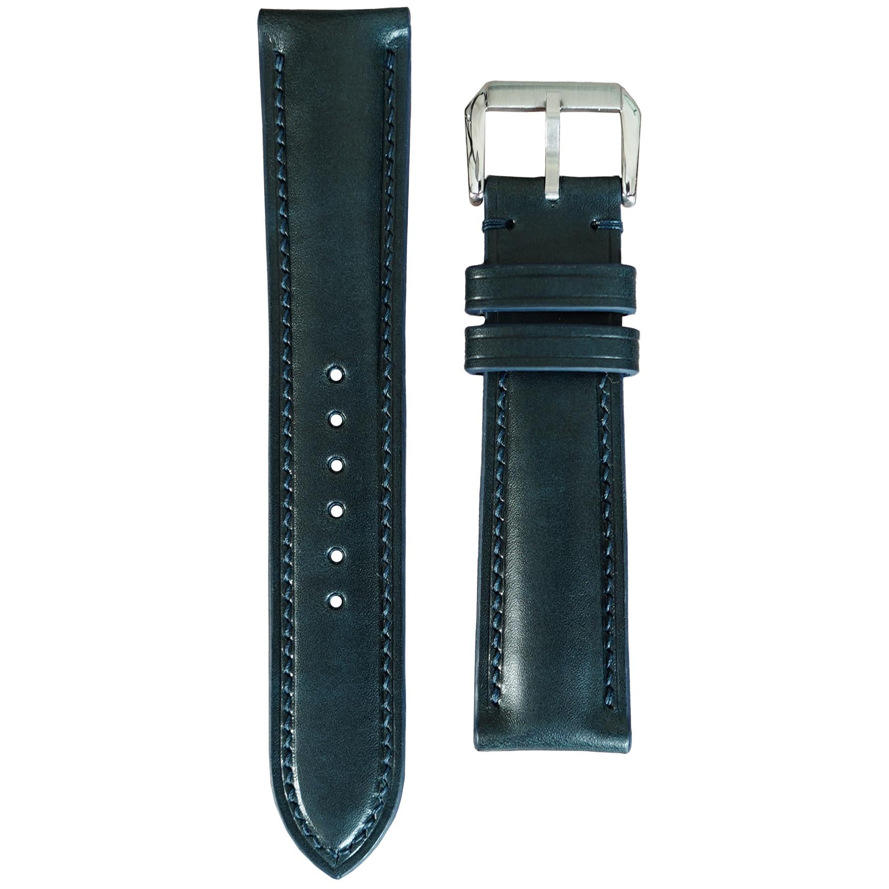 Deep teal Buttero leather watch strap with matching stitching and silver buckle, flat lay.