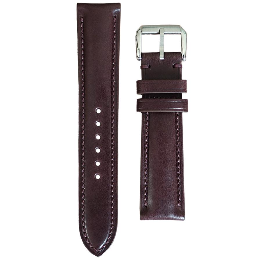 Bordeaux Buttero leather watch strap with matching stitching and silver buckle, flat lay.