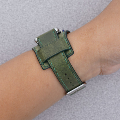 Cartier Tank Must with a green Buttero leather bund strap, strap detail on the wrist