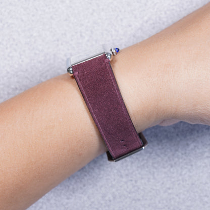 Cartier Tank Must with a maroon suede leather strap, strap detail on the wrist