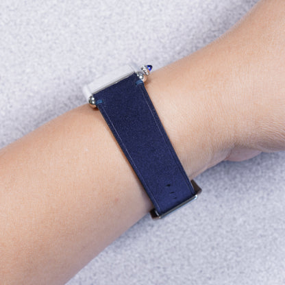 Cartier Tank Must with a midnight blue suede strap, strap detail on the wrist
