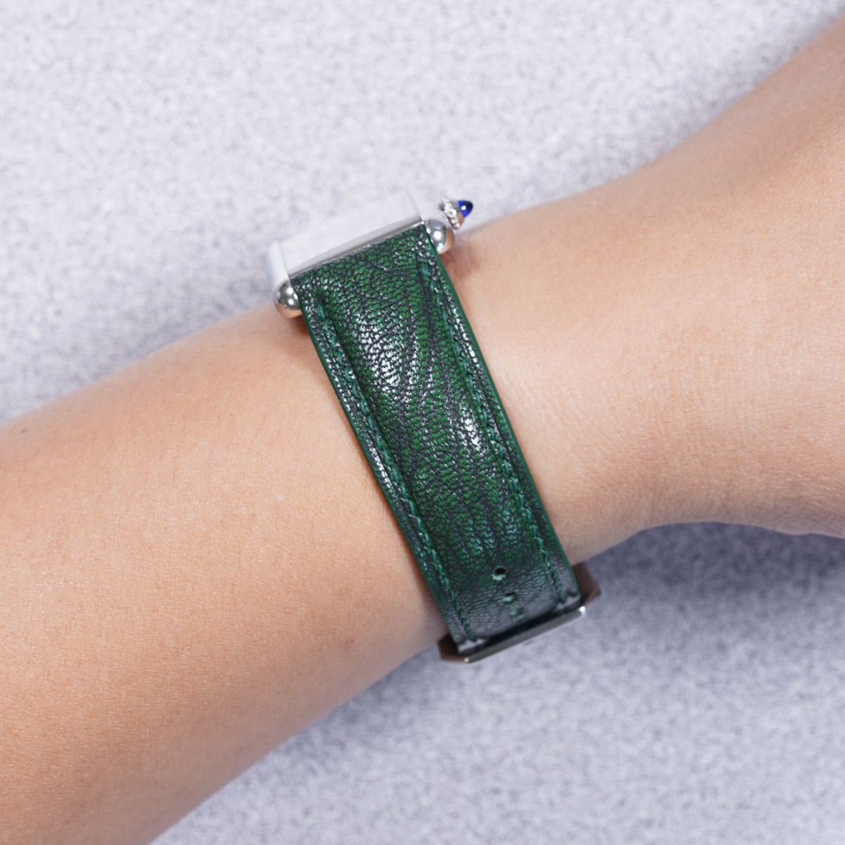 Cartier Tank Must with a basil green Alran Patnat goat leather strap, strap detail on the wrist
