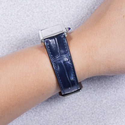 Cartier Tank Must with a dark blue crocodile leather strap, strap detail on the wrist