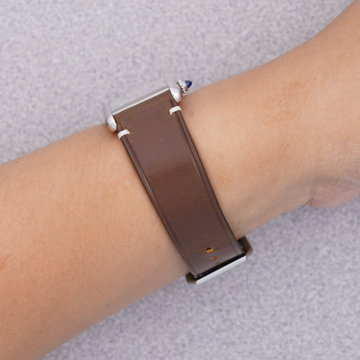 Cartier Tank Must with a cognac shell cordovan strap, strap detail on the wrist