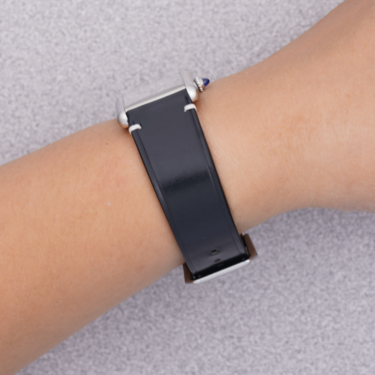 Cartier Tank Must with a black shell cordovan strap, strap detail on the wrist