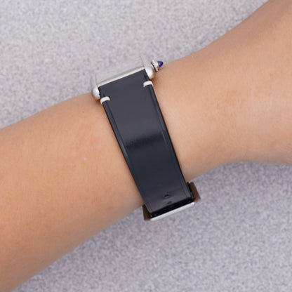 Cartier Tank Must with a black shell cordovan strap, strap detail on the wrist