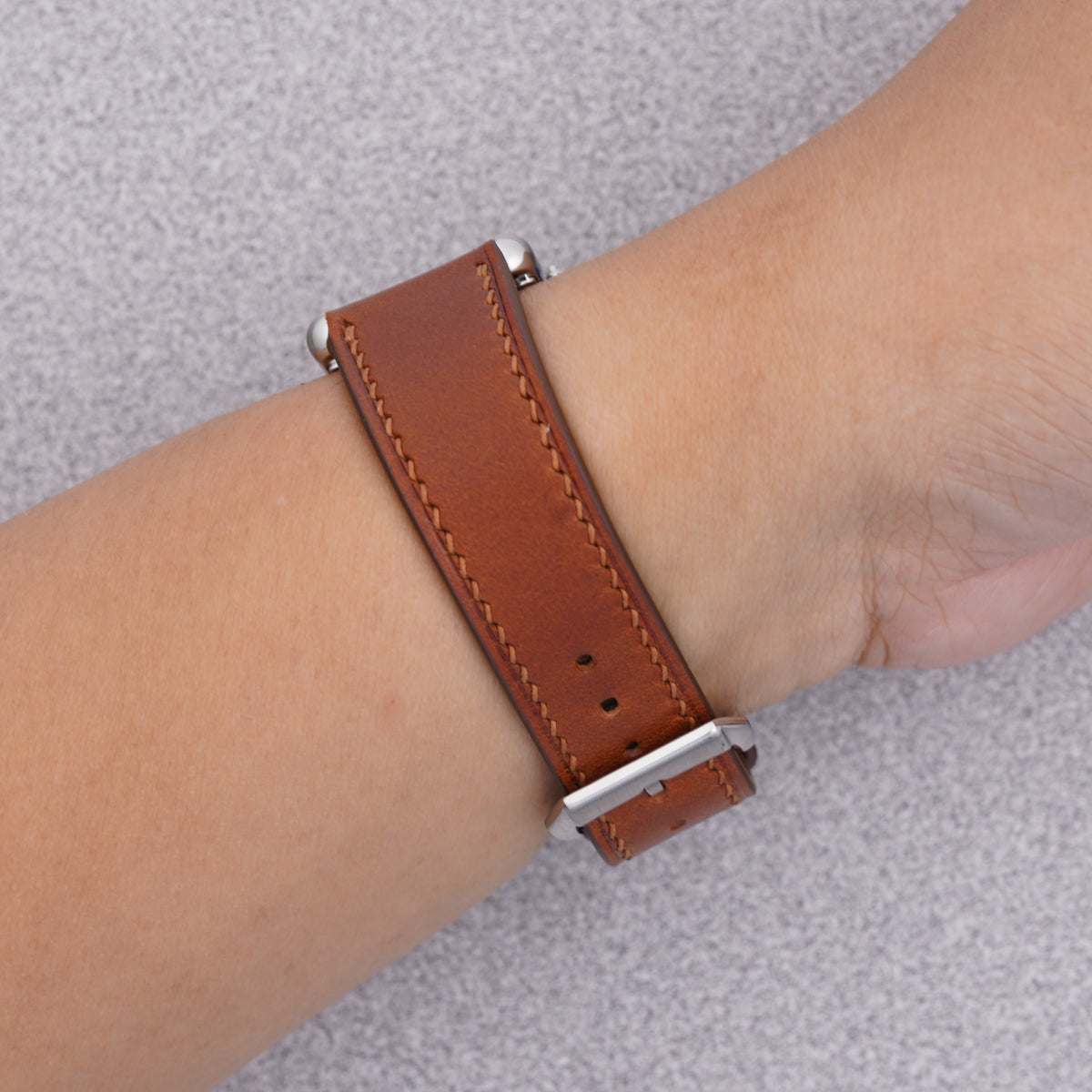 Cartier Tank Must with a brown Buttero leather strap, strap detail on the wrist