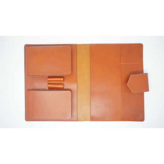 Buttero leather Macbook cover, open flat lay, with card slots, pen loop, and snap closure.
