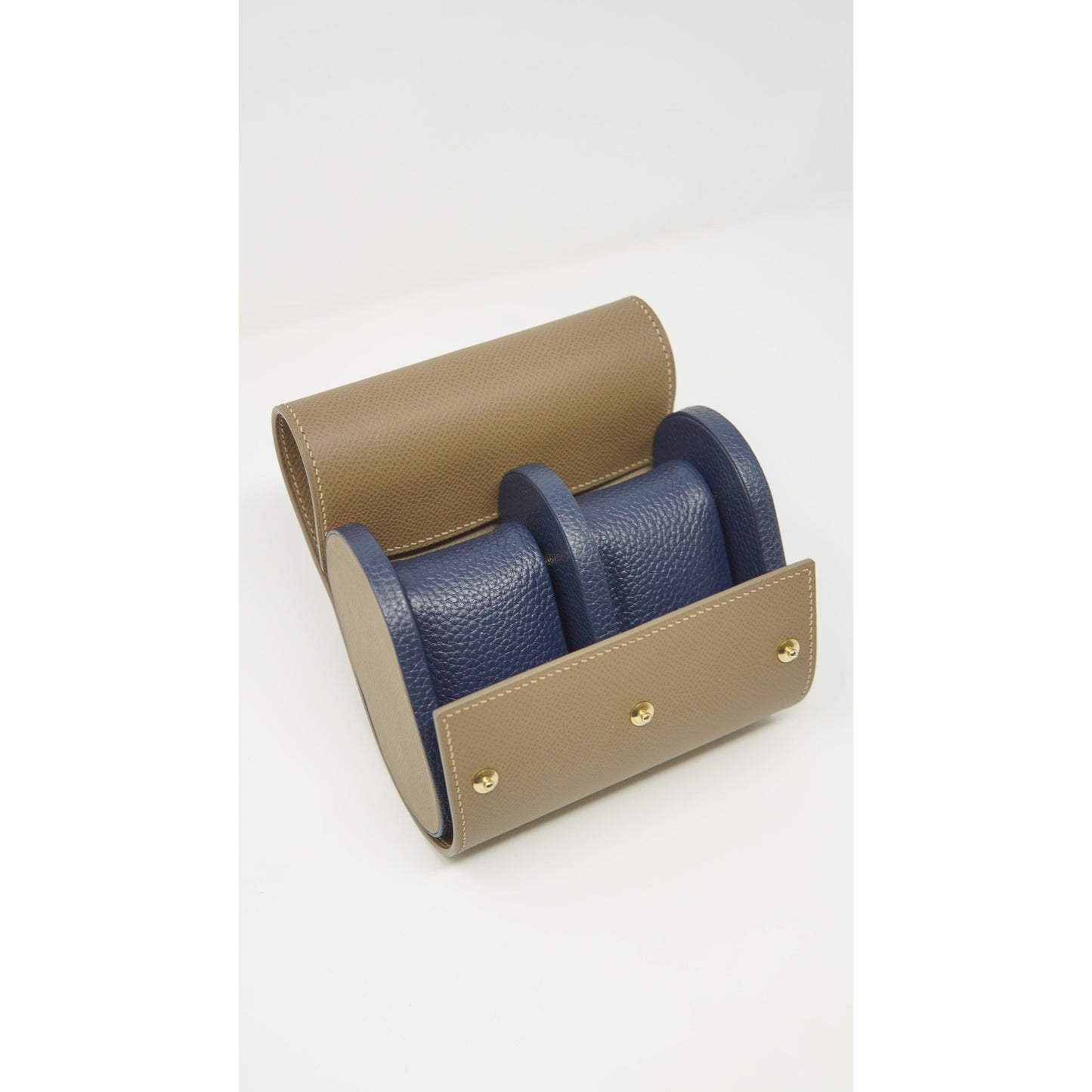 Tan and blue leather double watch roll with gold snaps, white stitching, and two blue leather watch strap cushions.