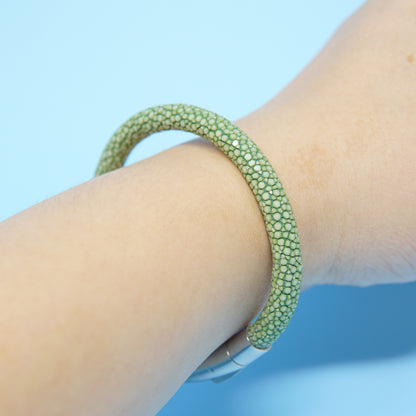 Green stingray leather watch strap bracelet on a wrist, with a silver clasp.