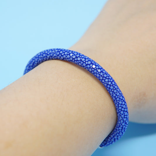 Blue stingray leather watch strap bracelet on wrist, close-up detail.