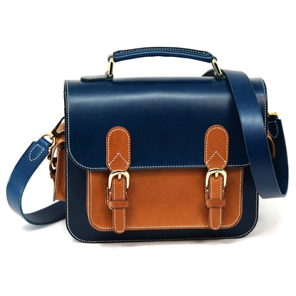 Blue and brown Italian Buttero leather messenger bag with gold buckles and white stitching.