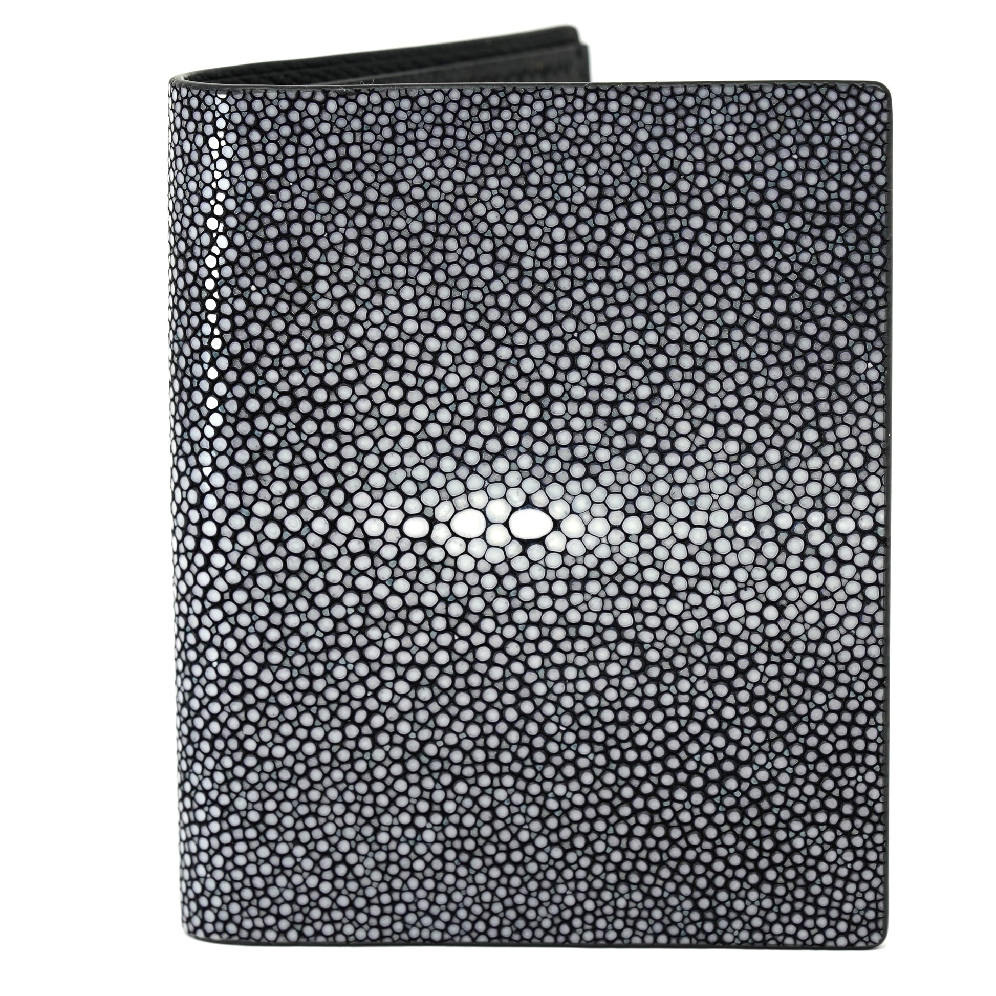 Black stingray leather wallet with textured surface and central white "eye" pattern, flat lay.