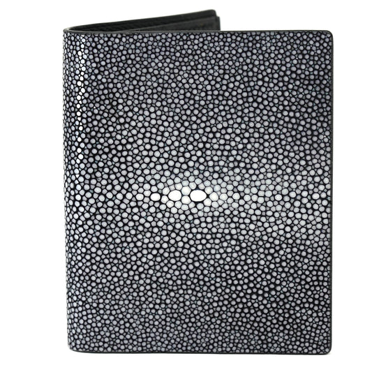Black stingray leather wallet with textured surface and central white "eye" pattern, flat lay.