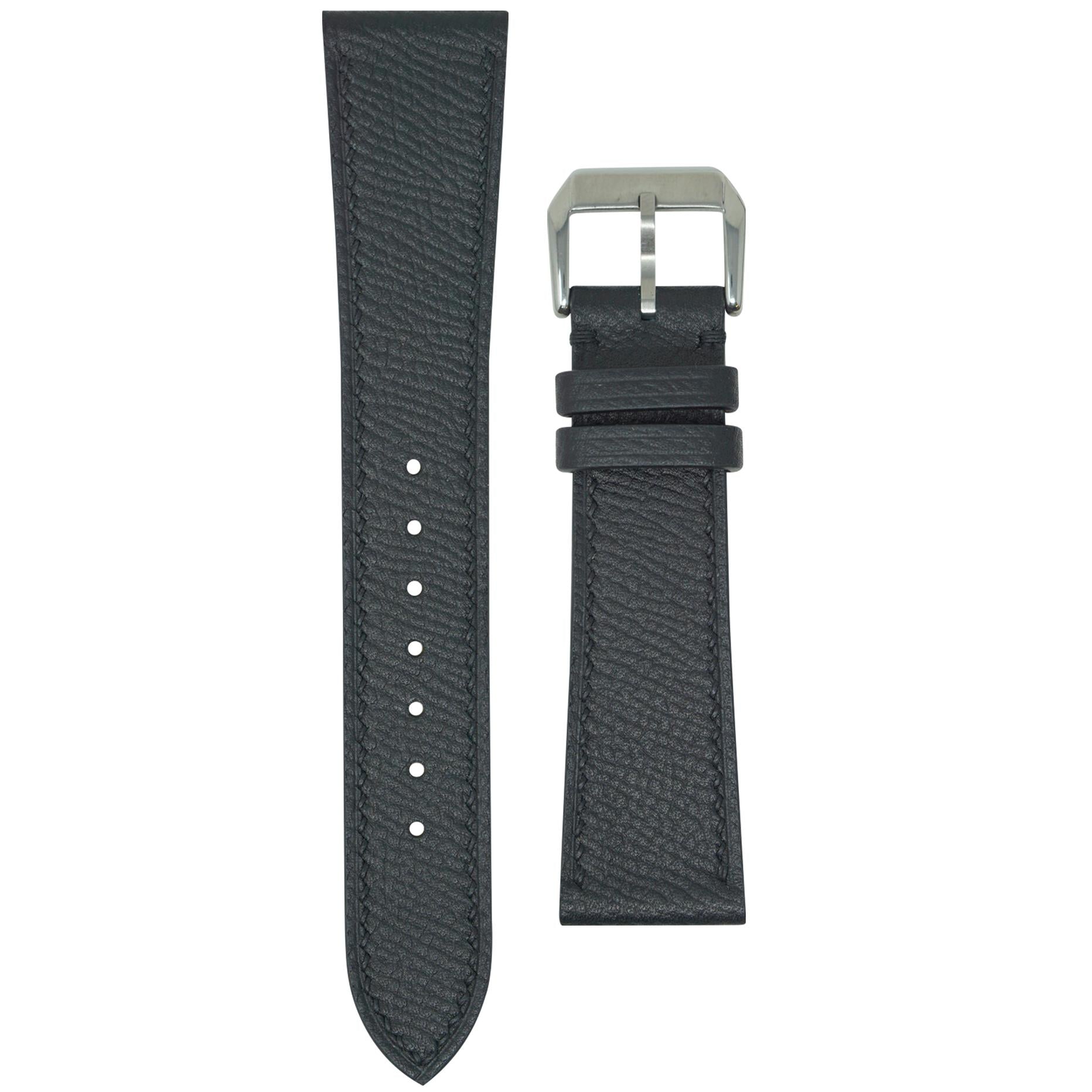 Black Epsom leather watch strap with matching stitching and a silver buckle, flat lay.