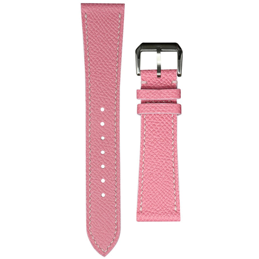 Pink Epsom leather watch strap with white stitching and silver buckle, flat lay.