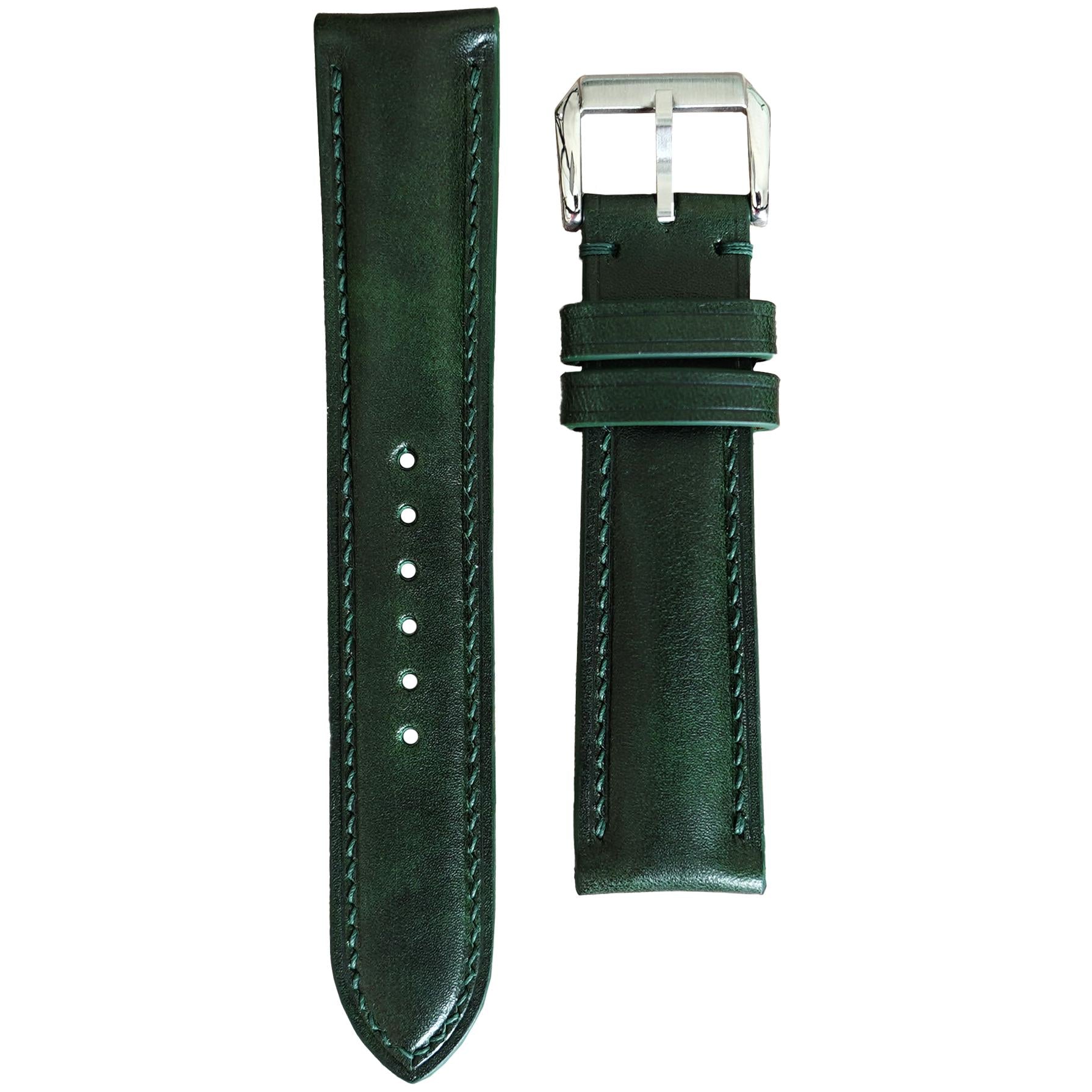 Deep green Buttero leather watch strap with matching stitching and a silver buckle, flat lay.