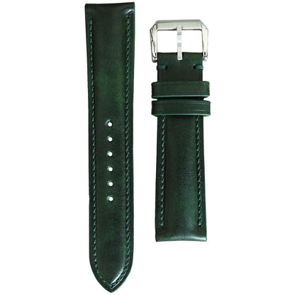 Deep green Buttero leather watch strap with matching stitching and a silver buckle, flat lay.