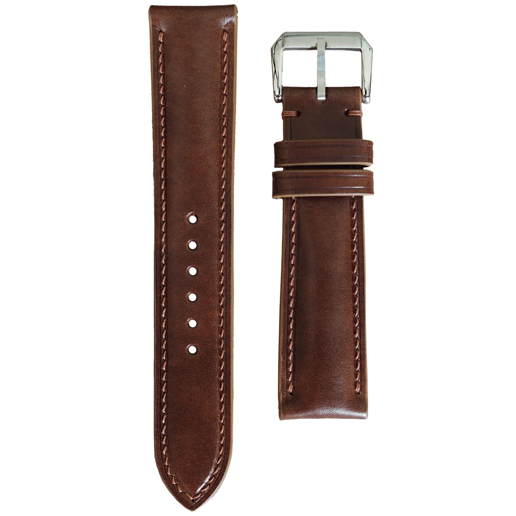 Chestnut Buttero leather watch strap with brown stitching and silver buckle, flat lay.