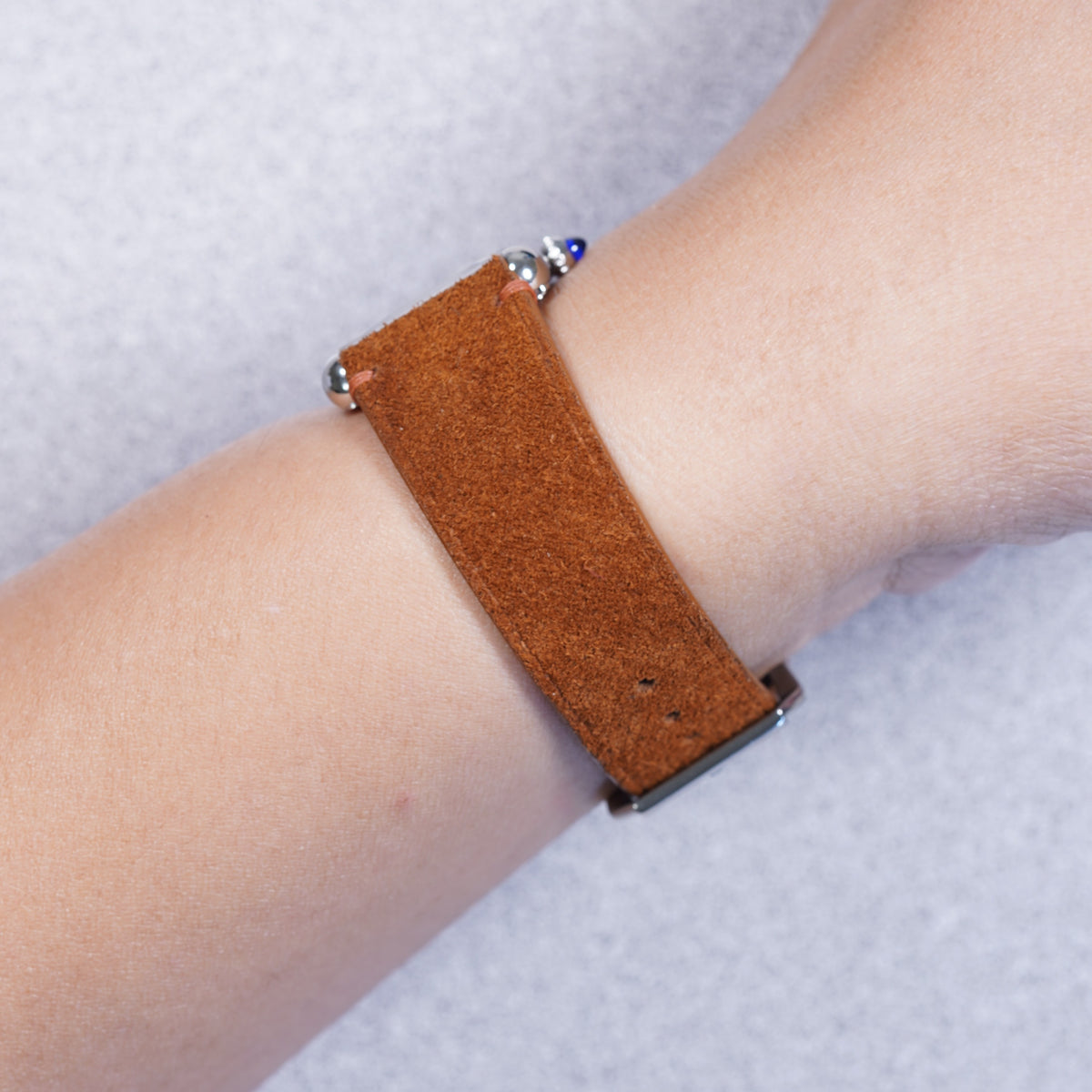 Cartier Tank Must with a whisky suede leather strap, strap detail on the wrist