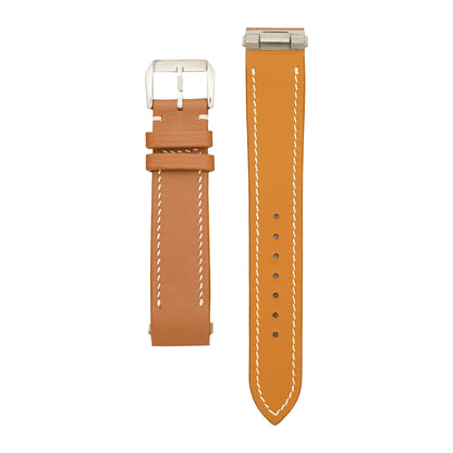 Brown Swift Cartier Roadster strap, buckle piece face up and long piece lining up to show the steel clip-in insert, flat lay.