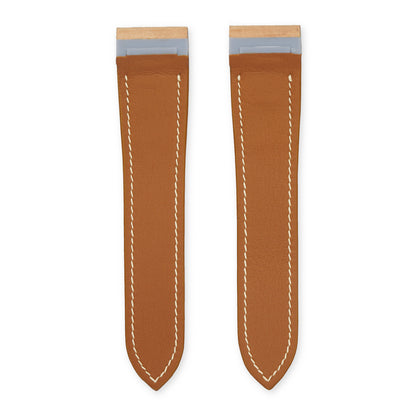 Underside of the natural shell cordovan Cartier Santos 100 strap, showing the stainless-steel end inserts and tan calfskin lining, flat lay.