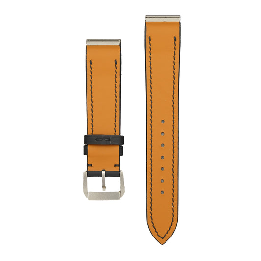 Underside of the black Swift Cartier Santos Galbée strap, showing the stainless-steel end inserts and tan calfskin lining, flat lay.