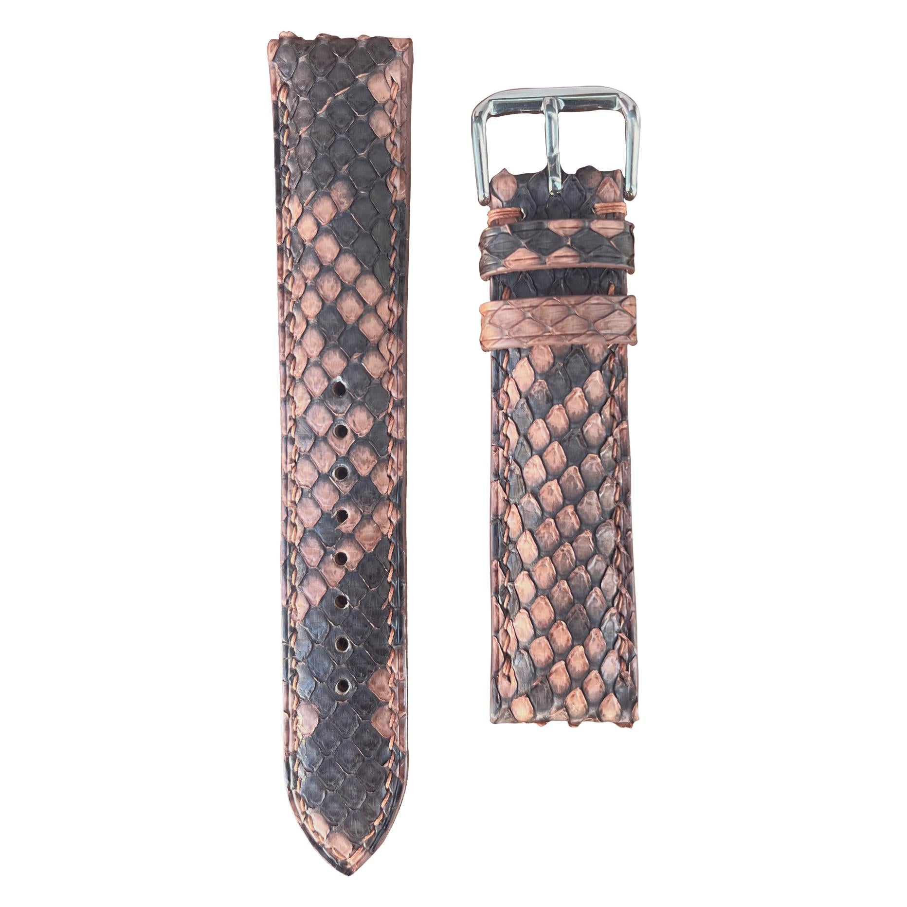 Copper snake skin leather watch strap with a silver buckle, flat lay.