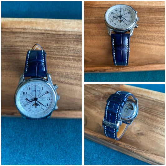 Three customer views of a dark blue crocodile leather watch strap fitted to a Longines chronograph.