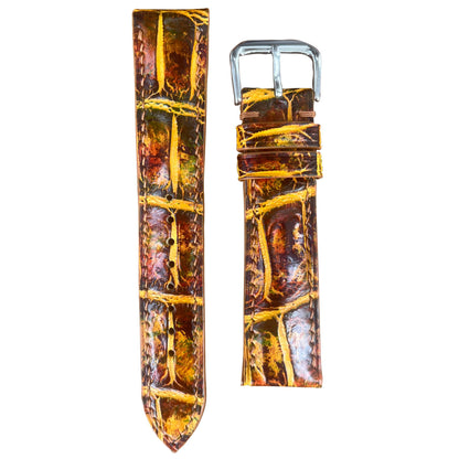 Brown and yellow crocodile leather watch strap with silver buckle, flat lay.