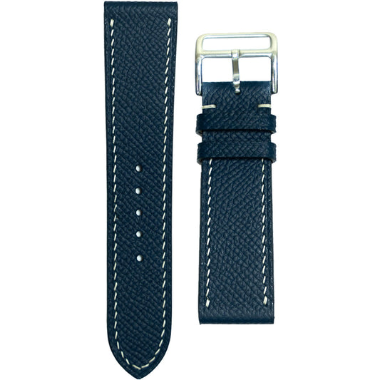 Navy Epsom leather watch strap with white stitching and silver buckle, flat lay.