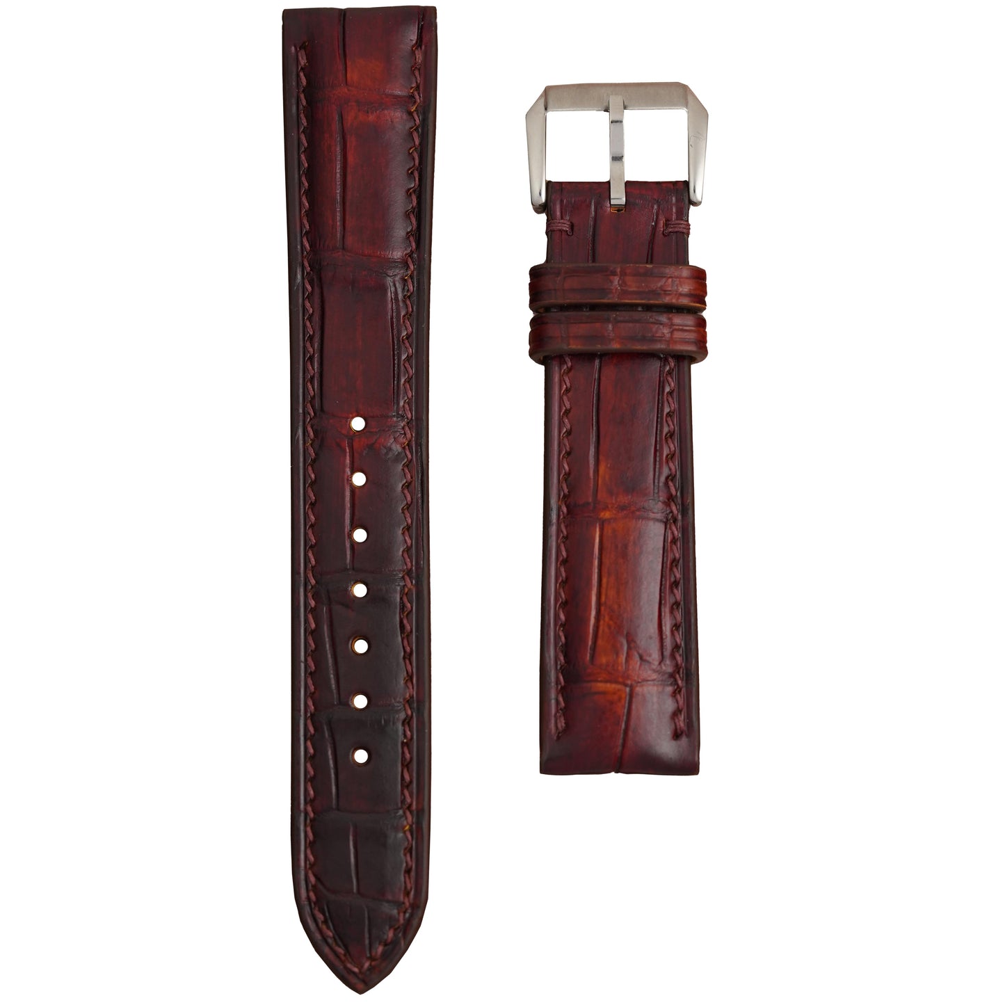 Oxblood brown crocodile leather watch strap with matching stitching and silver buckle, flat lay.