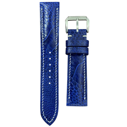 Blue ostrich leg leather watch strap with white stitching and silver buckle, flat lay.