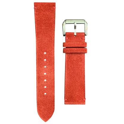 Red suede leather watch strap with silver buckle, flat lay.