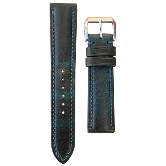 Teal Badalassi Wax leather watch strap with light blue stitching and silver buckle, flat lay.