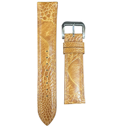 Light brown ostrich leg leather watch strap with silver buckle, flat lay.
