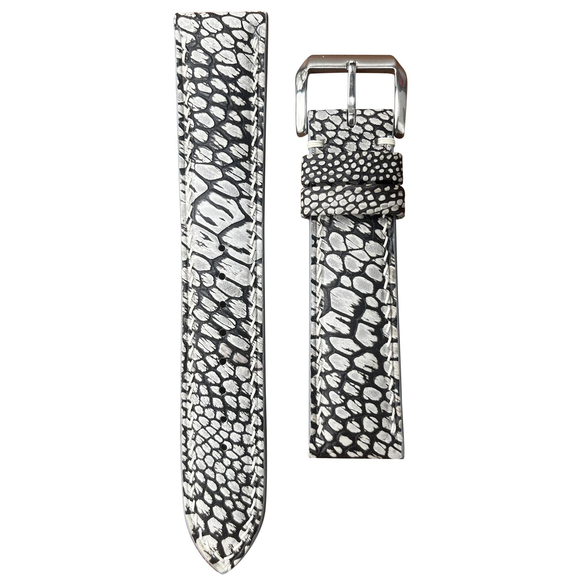 Gray ostrich leg stonewash leather watch strap with white stitching and silver buckle, flat lay.