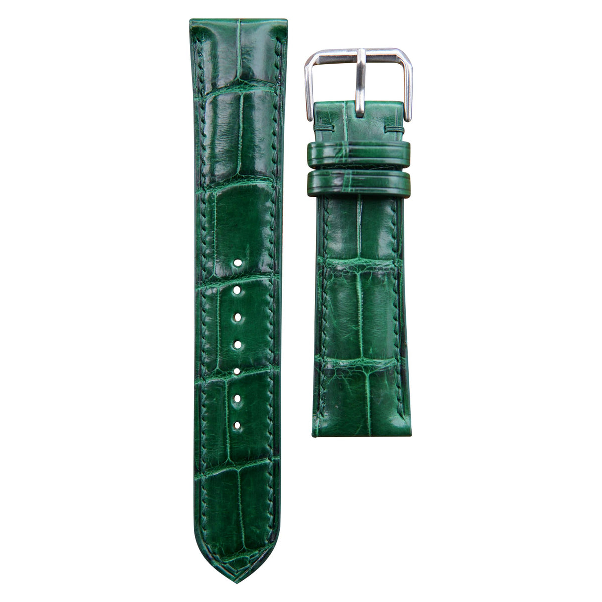 Green crocodile leather watch strap with matching stitching and silver buckle, flat lay.