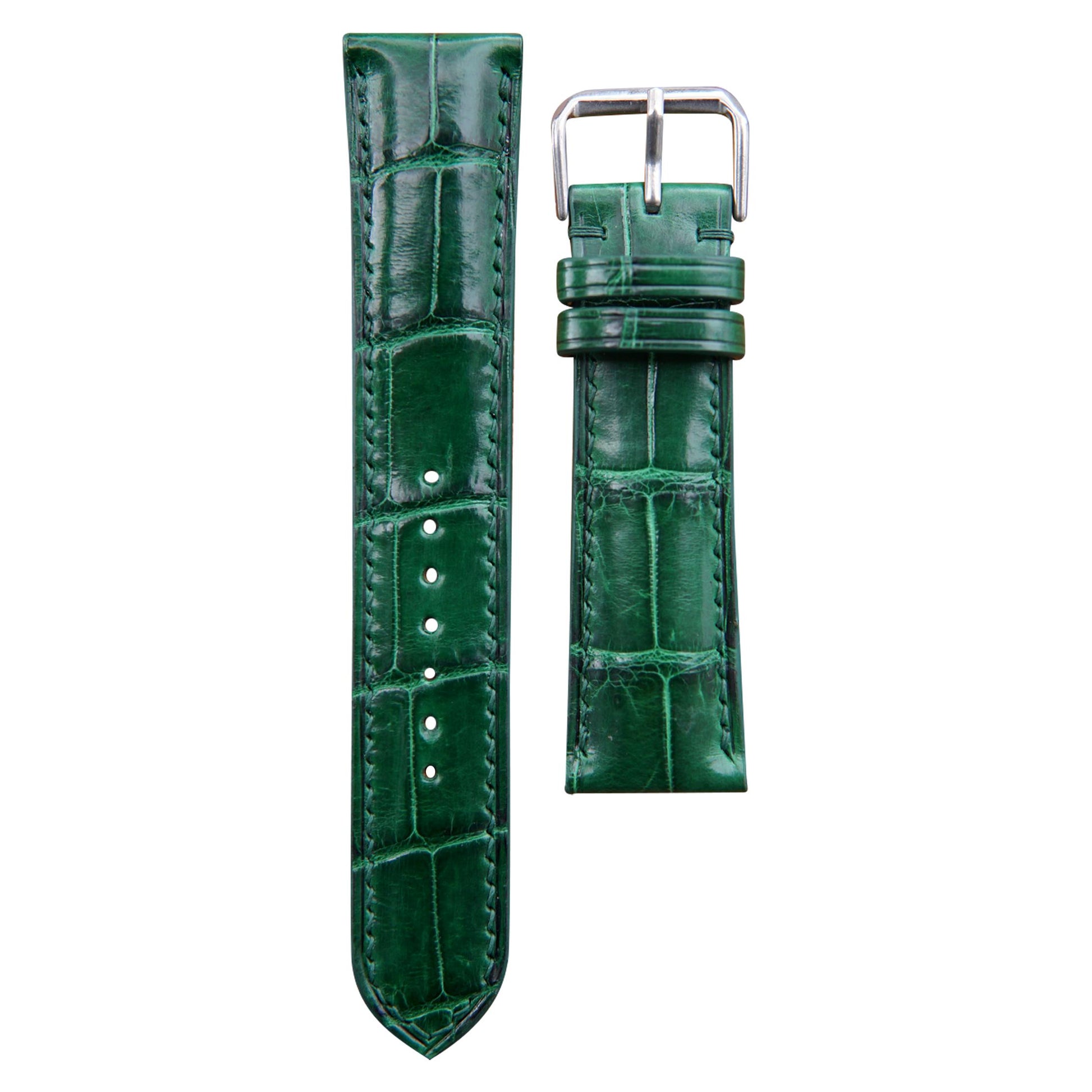 Green crocodile leather watch strap with matching stitching and silver buckle, flat lay.