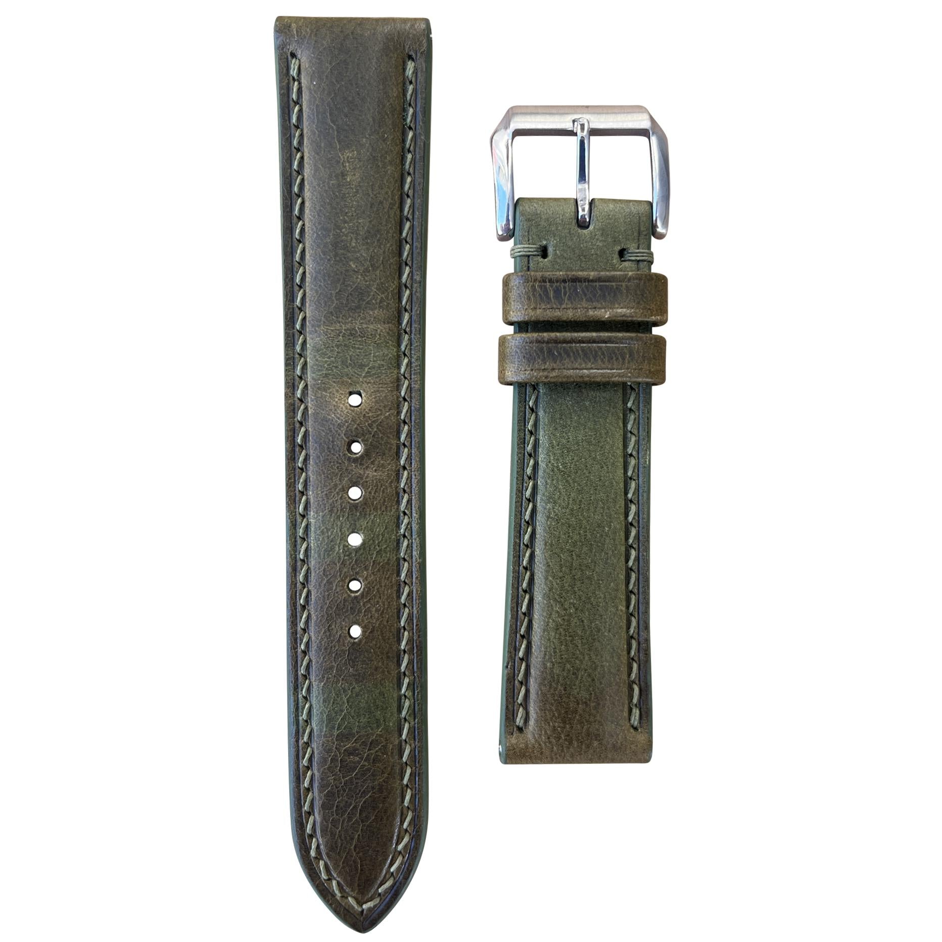 Olive green Badalassi Wax leather watch strap with light stitching and silver buckle, flat lay.