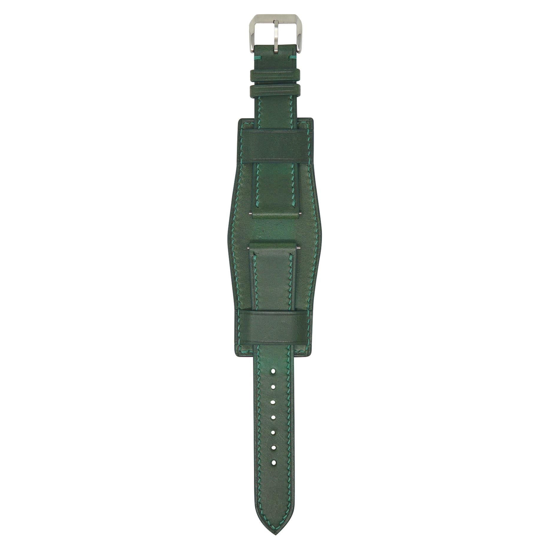 Green leather watch strap, Bund style, with matching stitching and a silver buckle, flat lay.
